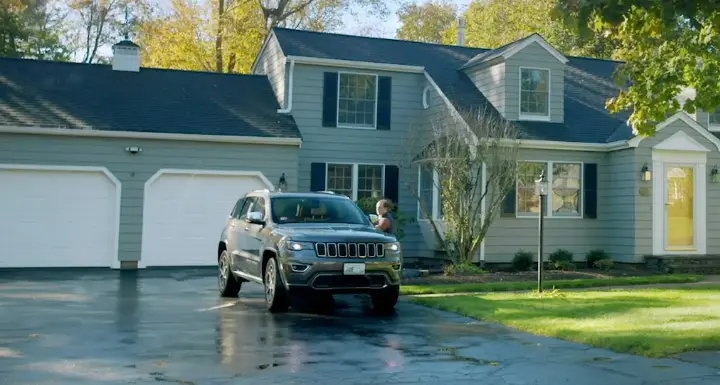 A jeep parked in front of a house featured in a portfolio.