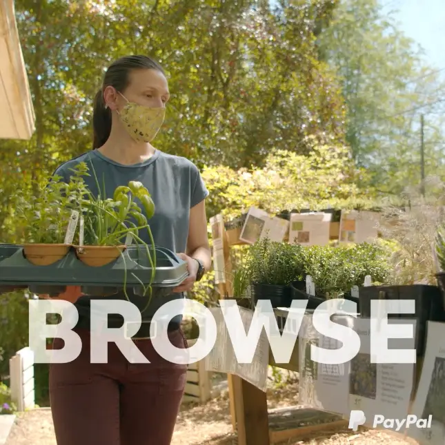 A woman holding a tray of plants with the words "browse our online community.