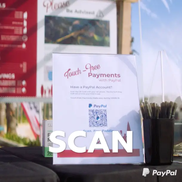A table with a sign that says PayPal payments scan for the payment platform.