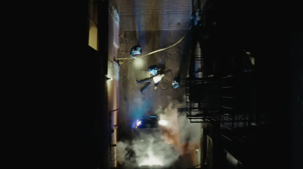 An aerial view of a fire in an alley at night, illuminating a true crime scene.