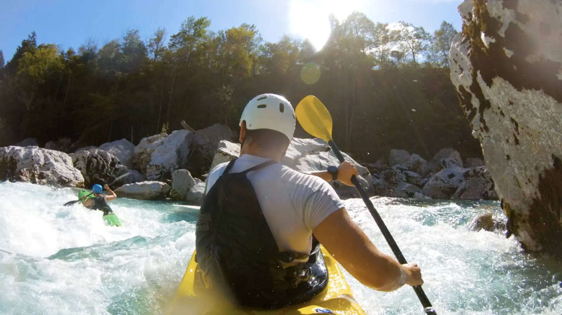 A man is kayaking down a river, turning his journey into a Trip Canvas masterpiece.
