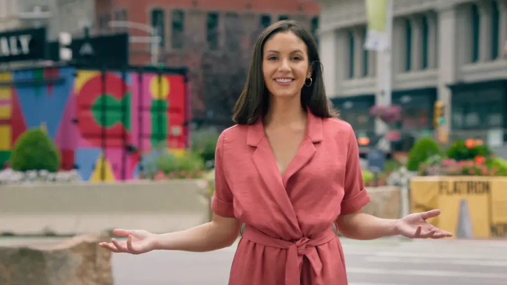 A woman in a pink dress is standing in the middle of the street for a CBS News NY brand campaign.