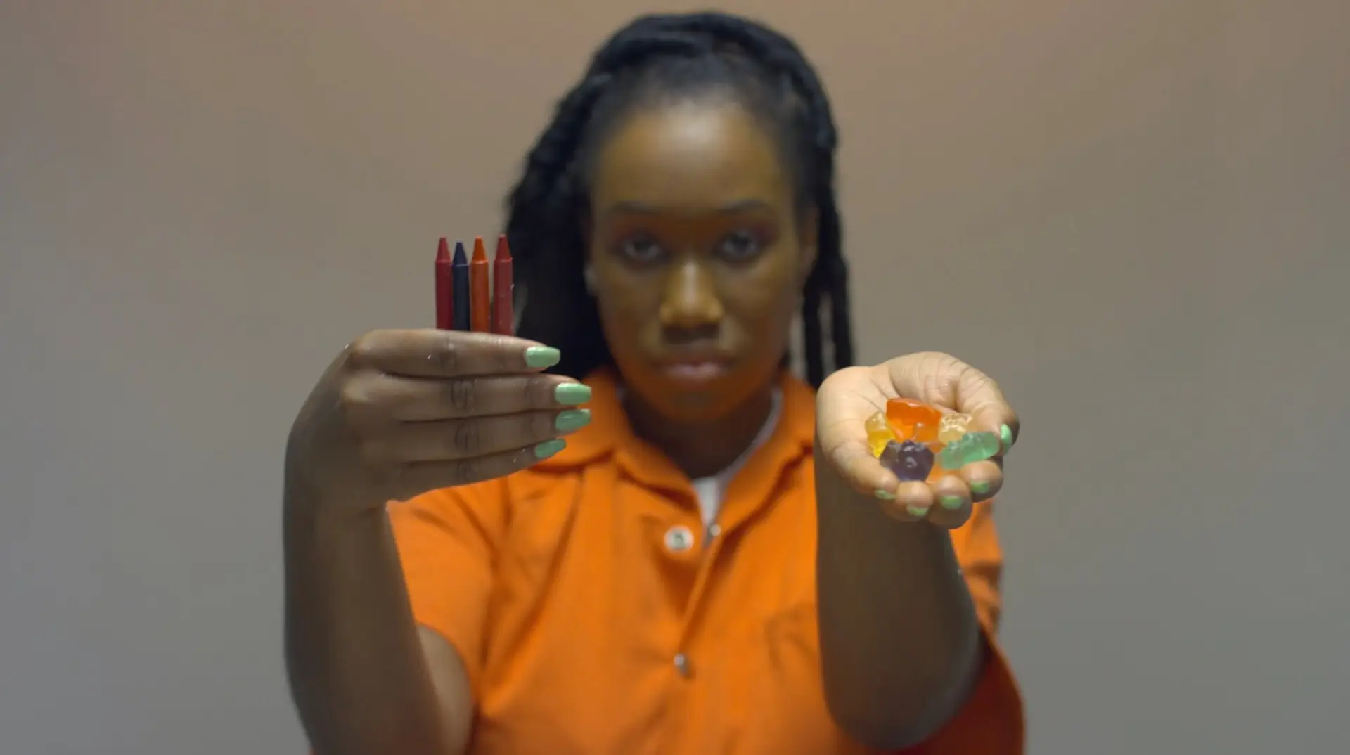 A woman in an orange shirt, reminiscent of "60 Days In," holding up gummy bears for the Fast Channel.