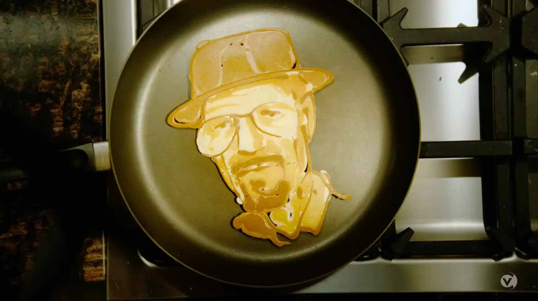 A pancake with a detailed portrait design cooking in a frying pan, ready to be added to your Sales Content Library.
